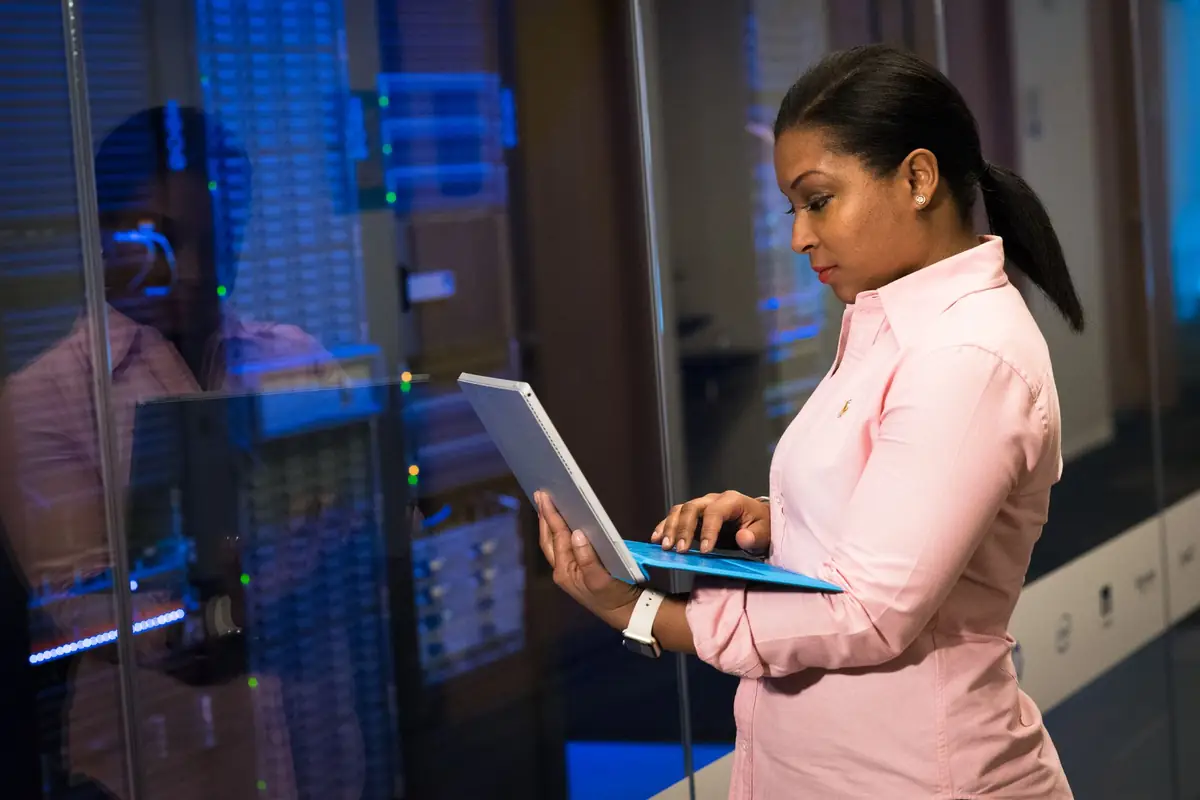 IT engineer working from a tablet in a server room