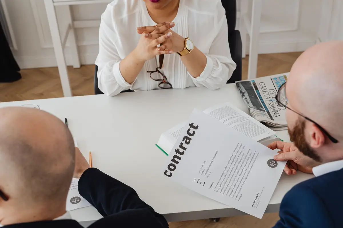 Two people reviewing a software contract across a table