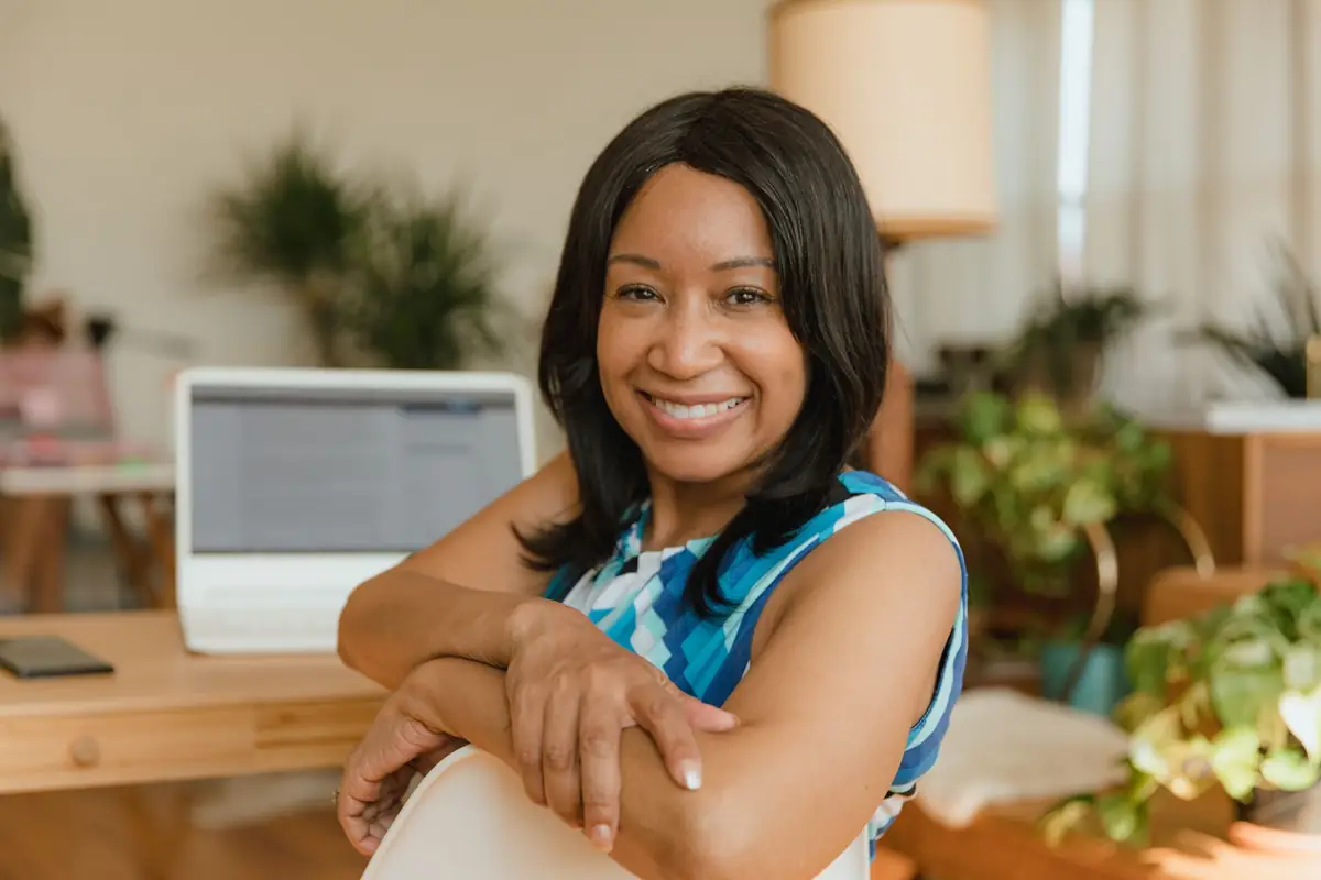 Business owner smiling at her desk in a small office