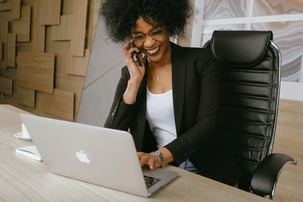 Marketing manager on a call while reviewing a laptop dashboard