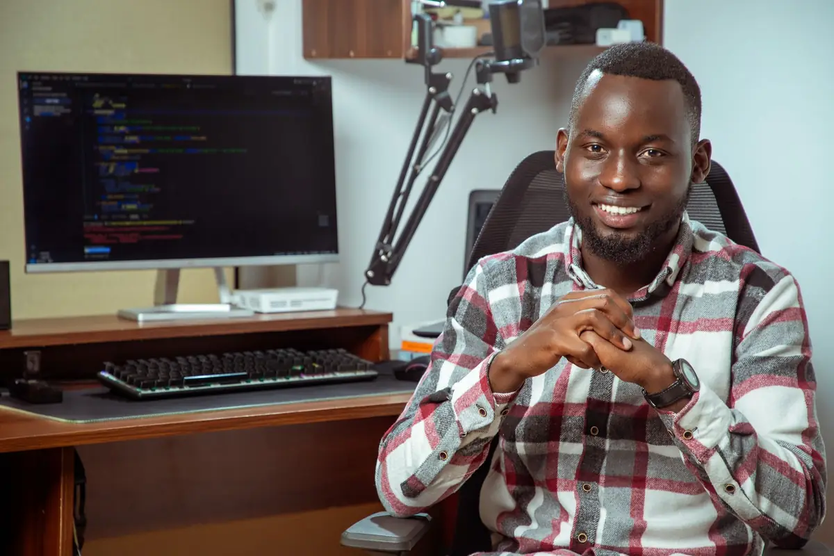Software developer working at a desk with code open on screen